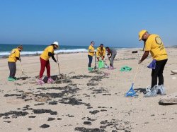 Волонтеры помогают очищать пляж после недавнего разлива нефти (Израиль)